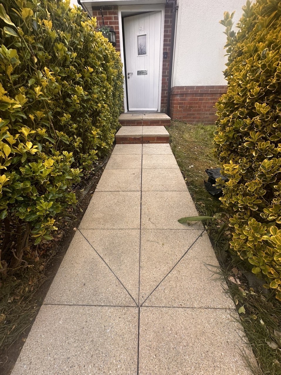 Clean front path leading to a house entrance
